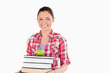 Beautiful female holding and a apple and books while posing