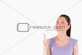 Cute woman pointing at a copy space