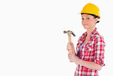 Beautiful woman holding a hammer while standing