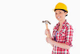 Attractive woman holding a hammer while standing