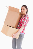 Good looking woman holding cardboard boxes while standing