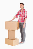 Beautiful woman posing with cardboard boxes while standing