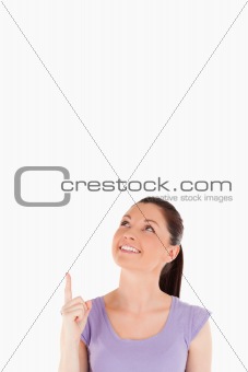 Good looking female pointing at a copy space