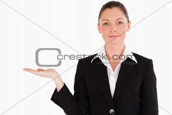 Lovely woman in suit showing a copy space while standing