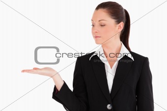 Beautiful woman in suit showing a copy space while standing