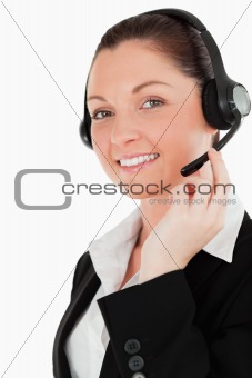Portrait of a lovely woman in suit using headphones and posing