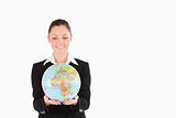 Attractive woman in suit holding a globe