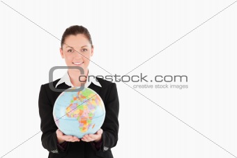 Charming woman in suit holding a globe