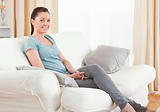 Beautiful woman posing while sitting on a sofa