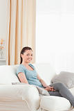 Attractive woman posing while sitting on a sofa