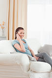 Good looking woman on the phone while sitting on a sofa