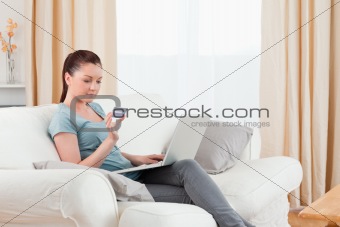 Lovely woman making an online payment with her credit card while