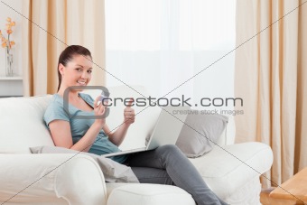 Attractive woman making an online payment with her credit card w