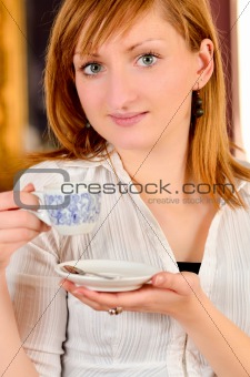 Beautiful young girl dtinking coffee