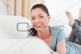 Beautiful woman posing while lying on a sofa