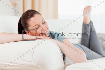 Charming woman posing while lying on a sofa