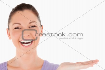 Portrait of a good looking woman showing a copy space while stan