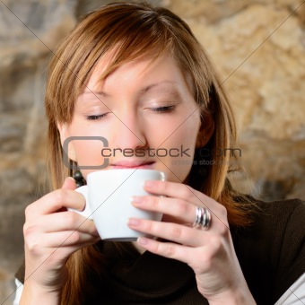 Beautiful young girl dtinking coffee