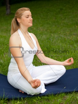 Meditation in nature - Cute young girl meditates outdoors