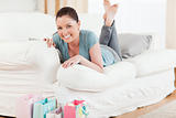 Good looking woman posing while lying on a sofa