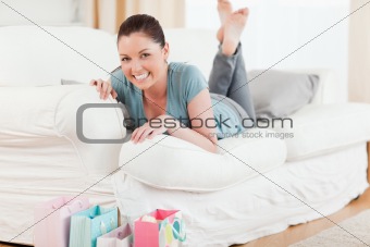 Good looking woman posing while lying on a sofa