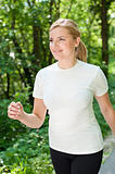 Cute active woman on a walk through forest 