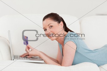 Side view of a beautiful woman making an online payment with her