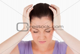 Portrait of an attractive woman having a headache while standing