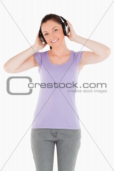 Good looking woman posing with headphones while standing