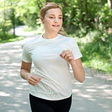 Attractive young woman on a run in nature