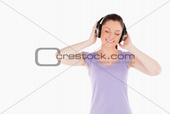 Pretty woman posing with headphones while standing