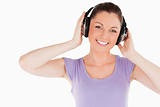 Cute woman posing with headphones while standing