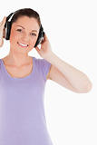 Attractive female posing with headphones while standing