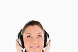 Portrait of a gorgeous woman posing with headphones while standi