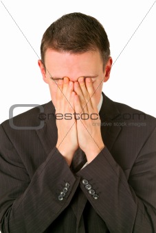 Businessman hiding his face in shame