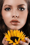 summer portrait of a young girl with sunflower