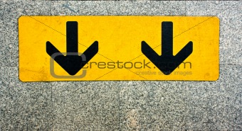 Two black arrow on yellow plate