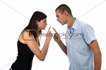 Young couple pointing fingers at each other isolated on white