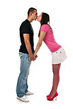 Young girl kisses her boyfriend while holding his hands isolated on white