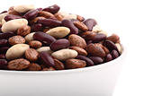 Various bean types in white bowl isolated on white