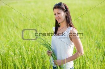 Attractive young woman on grain field