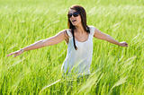 Attractive young woman on grain field
