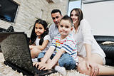 happy young family have fun and working on laptop at home