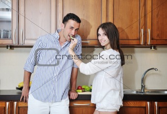 happy young couple have fun in modern kitchen