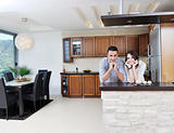 happy young couple have fun in modern kitchen