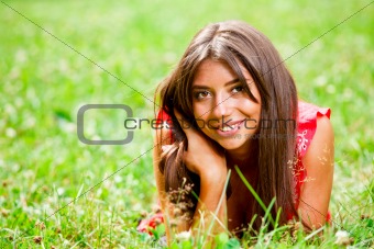 Beautiful woman lying on a grass
