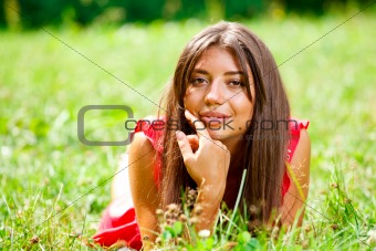Beautiful woman lying on a grass