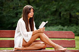 Beautiful woman reading small book
