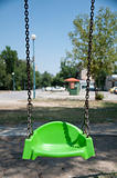 Empty green swing with chain