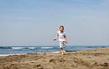 little boy running on beach